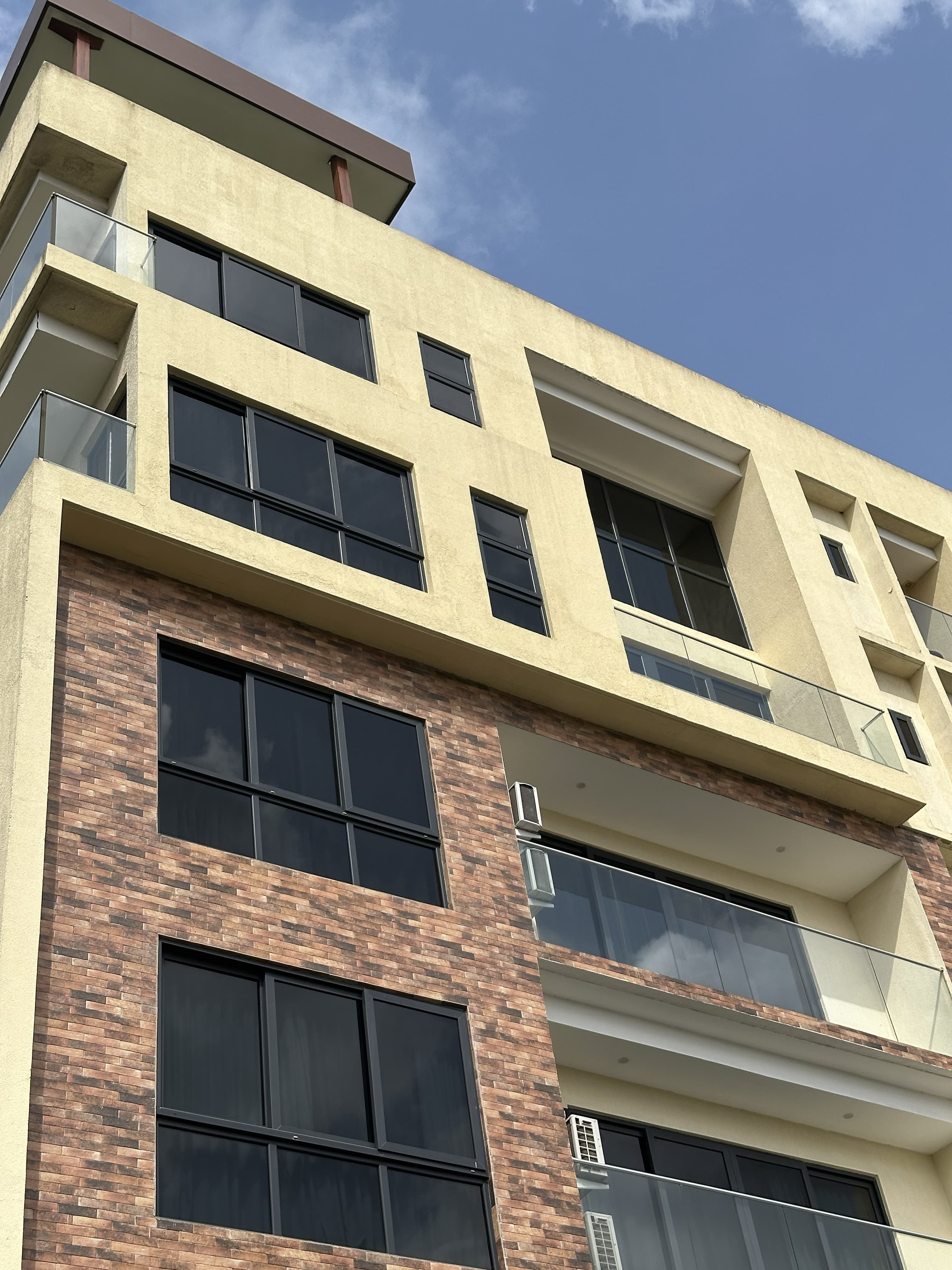 Multi-story building with exterior glass balcony balustrades