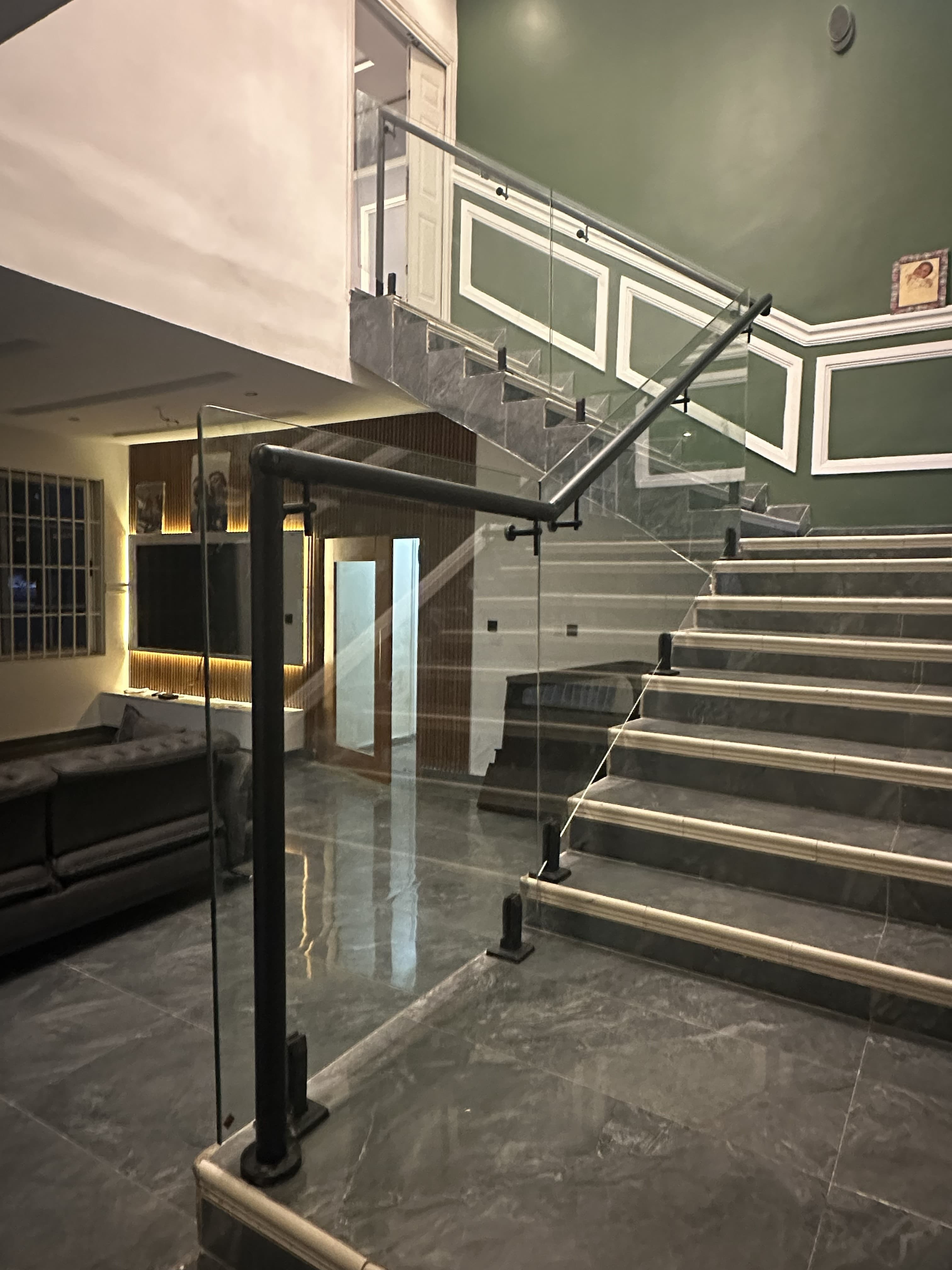 Interior glass staircase balustrade with black hardware