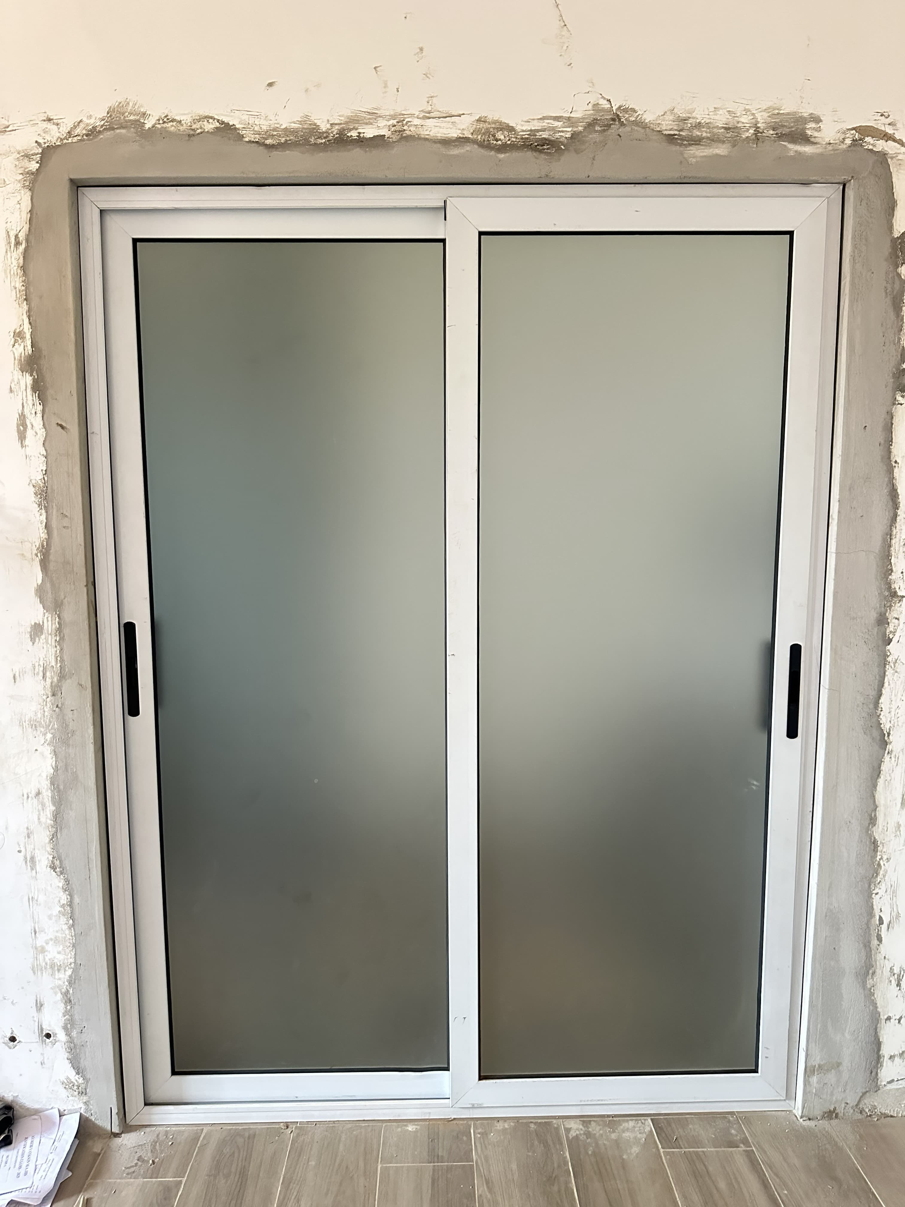 White aluminum-framed frosted glass sliding door