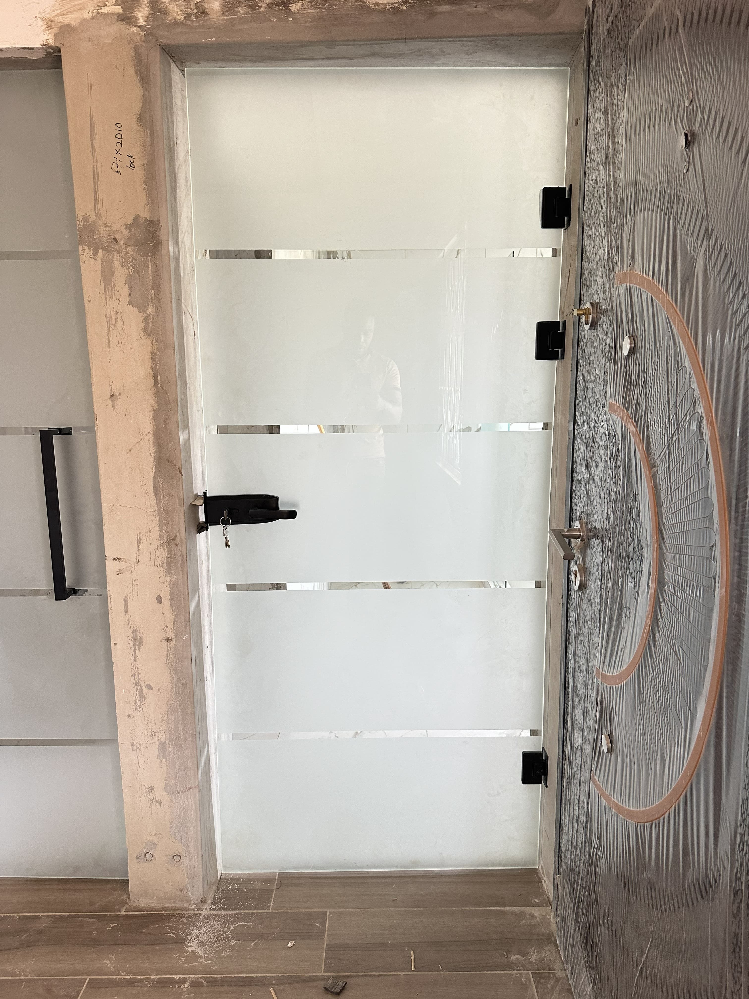 Frameless glass interior door with black fittings