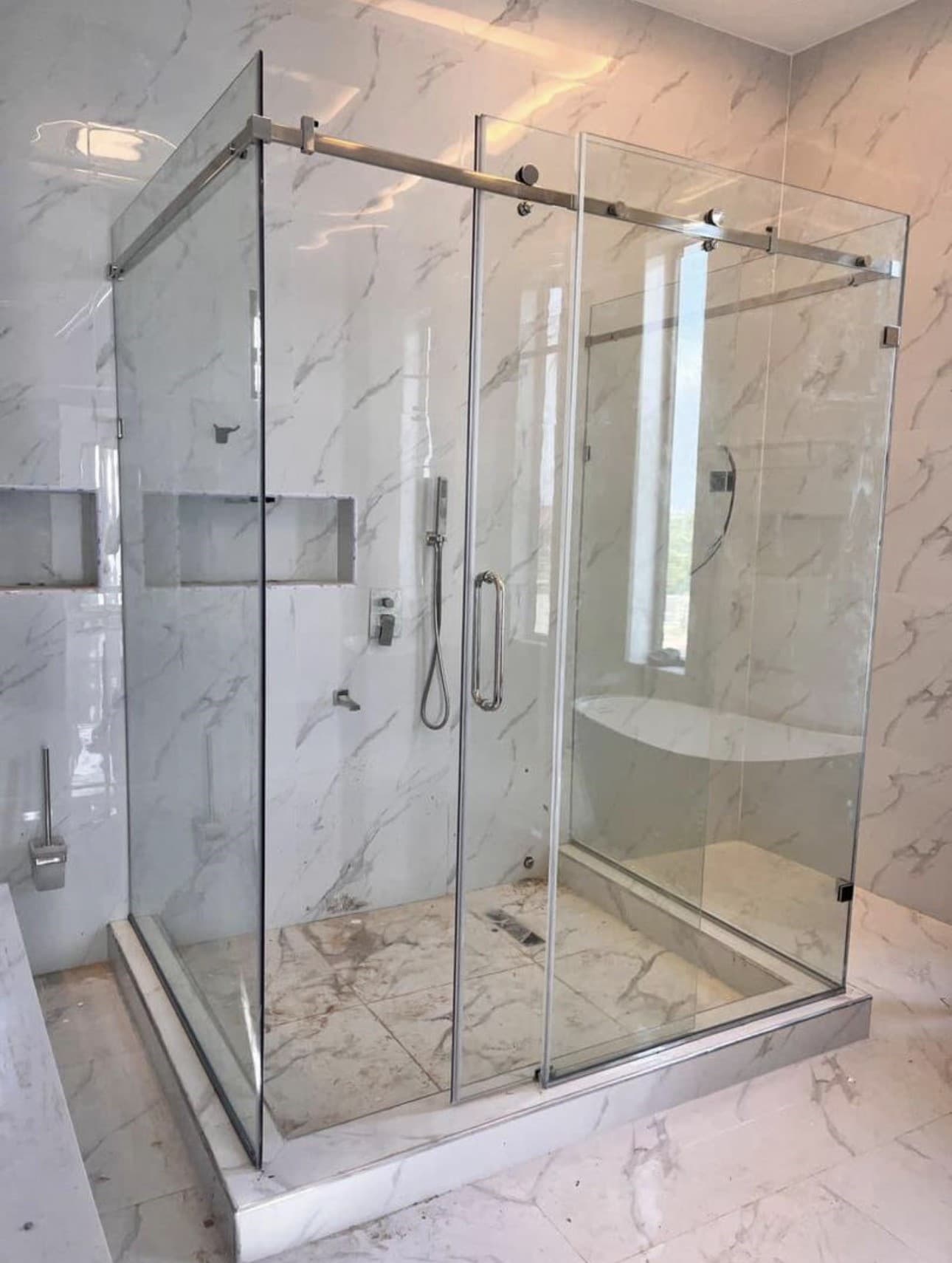 Clear sliding glass shower enclosure
